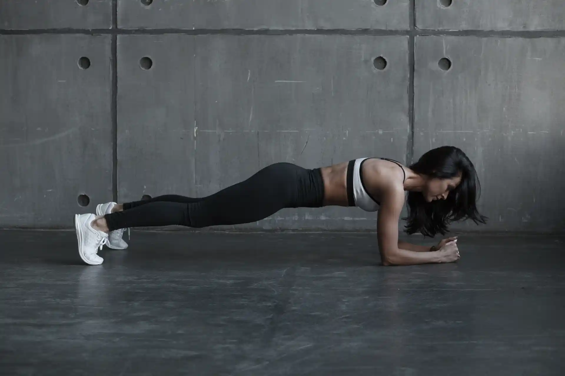 Woman performing a plank exercise in a fitness studio